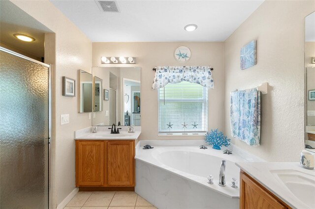 bathroom with vanity, plus walk in shower, and tile patterned flooring