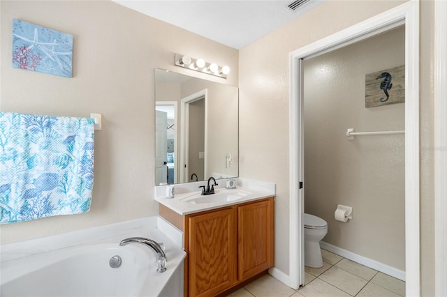 bathroom with tile patterned floors, a washtub, vanity, and toilet