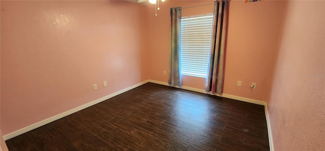 spare room with dark hardwood / wood-style flooring