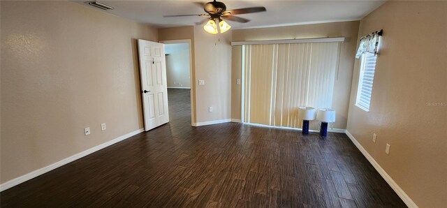 unfurnished bedroom featuring ceiling fan and dark hardwood / wood-style floors