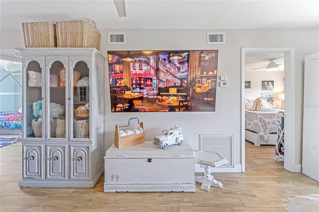 interior space featuring ceiling fan and a textured ceiling