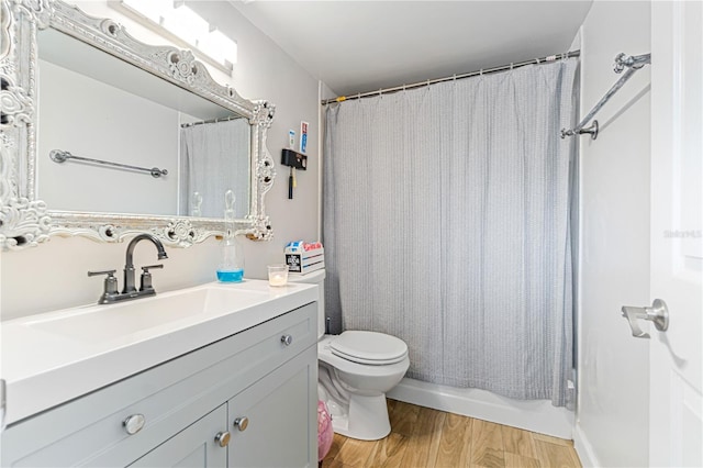 full bathroom with vanity, toilet, wood-type flooring, and shower / tub combo with curtain