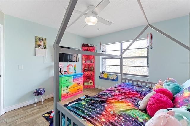 bedroom with hardwood / wood-style flooring and ceiling fan