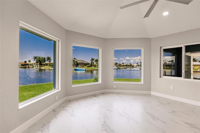 interior space with a water view and ceiling fan