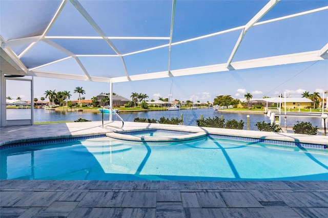 view of pool featuring a lanai, a patio area, and a water view