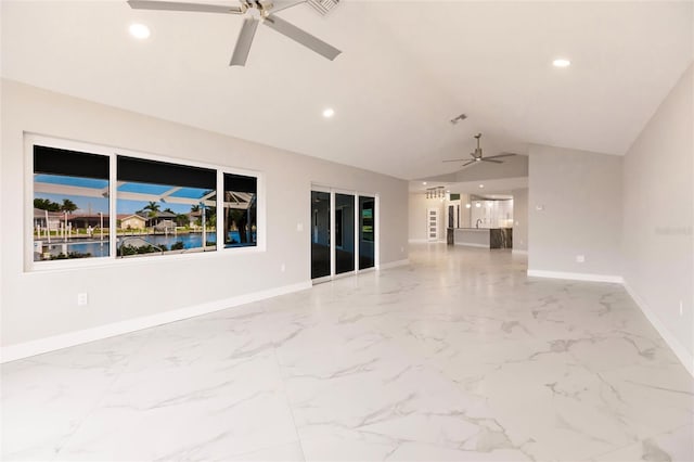 unfurnished living room featuring ceiling fan and lofted ceiling