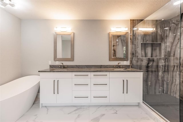 bathroom featuring plus walk in shower, vanity, and a textured ceiling