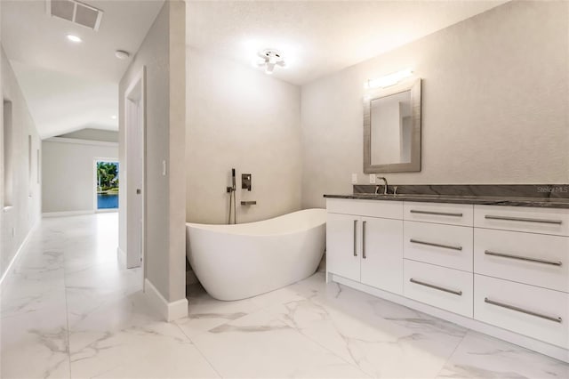 bathroom featuring a bathing tub and vanity