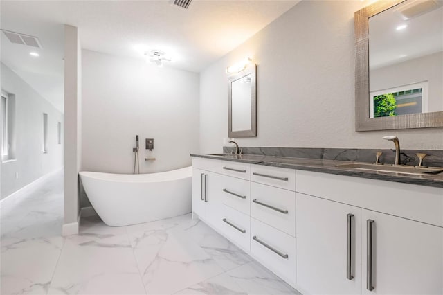 bathroom with vanity and a bathing tub