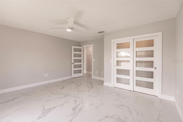 empty room featuring french doors and ceiling fan