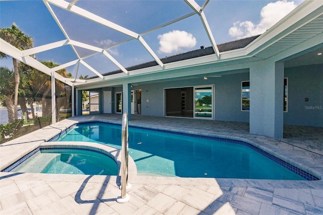 view of swimming pool featuring glass enclosure and a patio