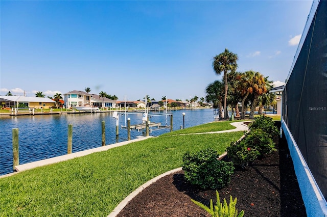 dock area with a water view and a yard