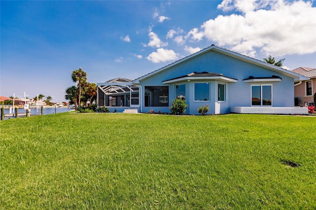 view of front of home featuring glass enclosure, a water view, and a front yard