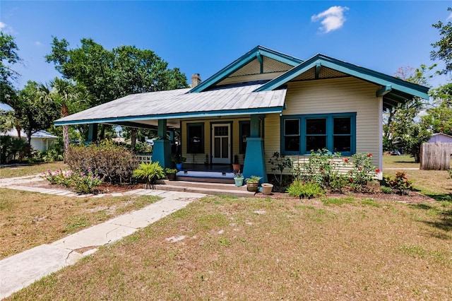 view of front of home featuring a front yard and a porch