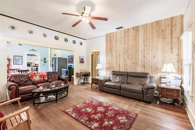 living room with hardwood / wood-style flooring and ceiling fan