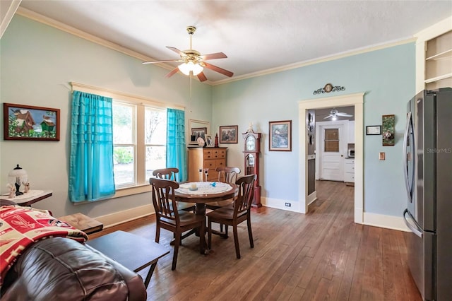 dining space with ceiling fan, crown molding, and wood-type flooring