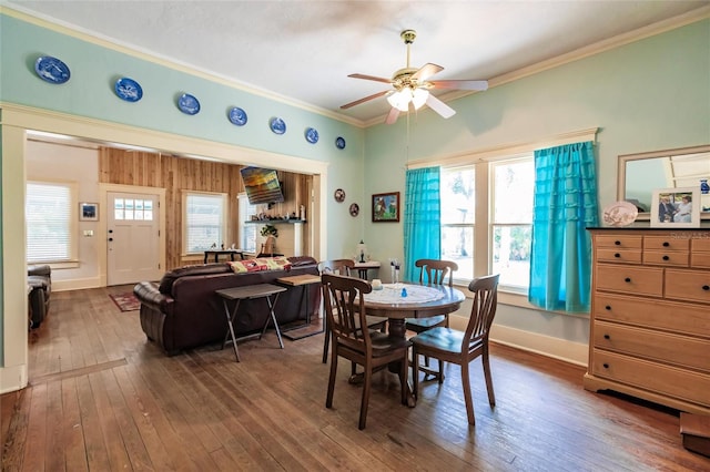 dining room with dark wood-type flooring, ceiling fan, and crown molding