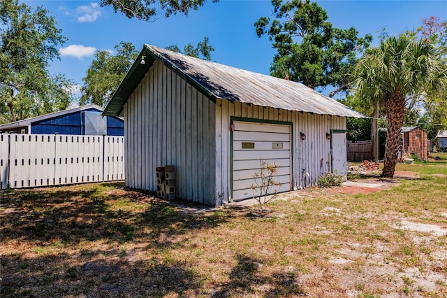 garage featuring a lawn