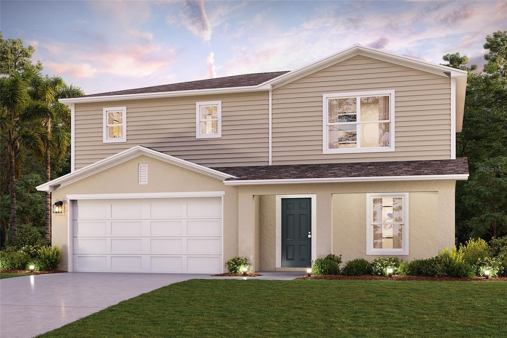 view of front of property featuring a garage and a yard