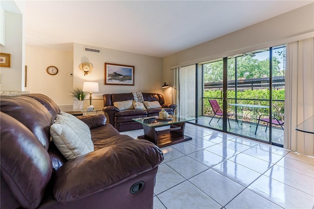 living area with visible vents and light tile patterned floors