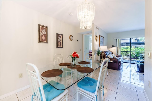 dining space with light tile flooring and a chandelier