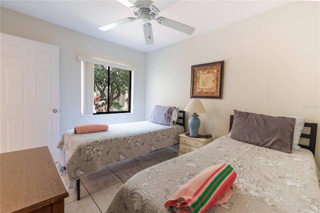 bedroom with ceiling fan and tile floors