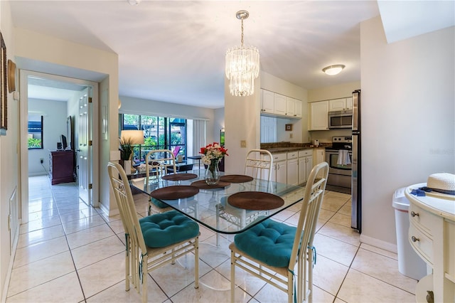 dining area featuring a chandelier and light tile floors