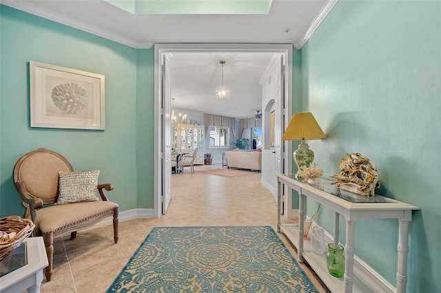 interior space featuring tile flooring, a chandelier, and crown molding