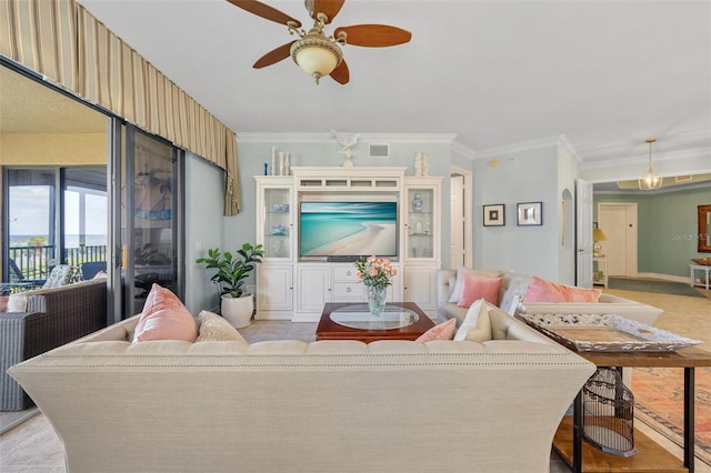 living room with ceiling fan, crown molding, and light carpet