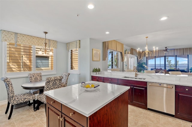 kitchen featuring an inviting chandelier, decorative light fixtures, sink, dishwasher, and light tile floors