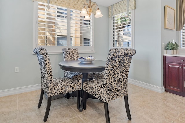 tiled dining space featuring a notable chandelier