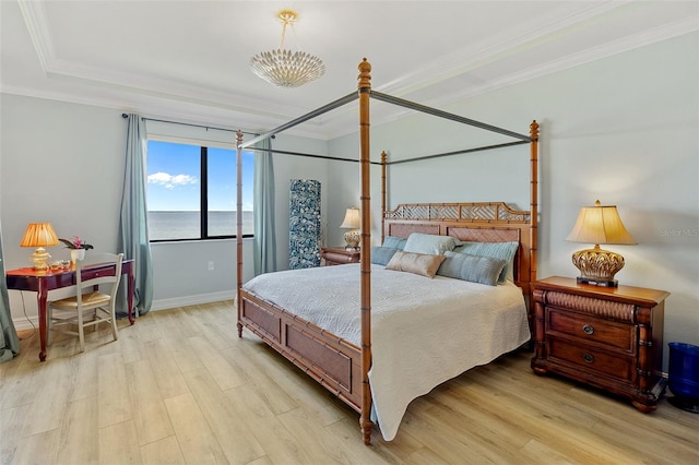 bedroom with ornamental molding, an inviting chandelier, a water view, and light hardwood / wood-style flooring