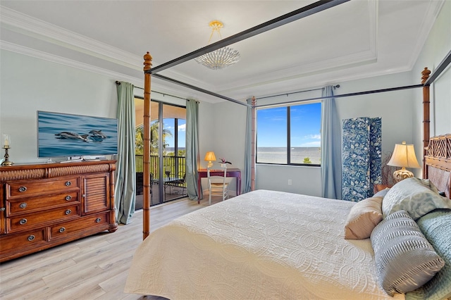 bedroom featuring a tray ceiling, light hardwood / wood-style floors, access to outside, and crown molding