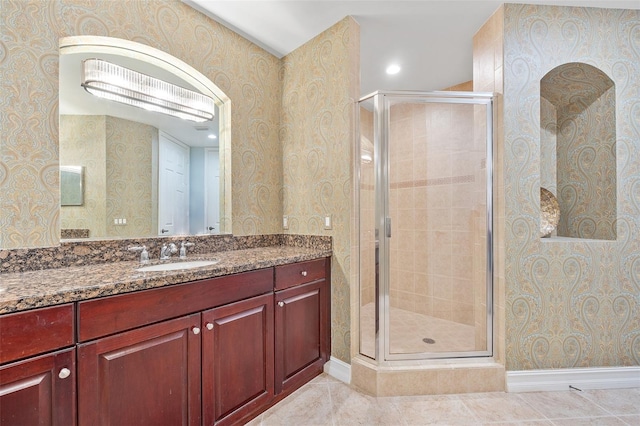 bathroom with an enclosed shower, tile flooring, and vanity