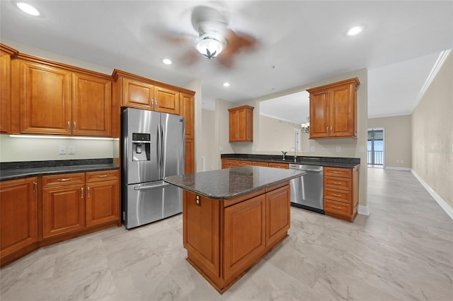 kitchen with a center island, appliances with stainless steel finishes, ceiling fan, and light tile floors