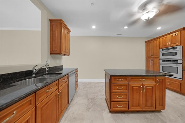 kitchen with a center island, light tile floors, sink, dark stone counters, and stainless steel appliances