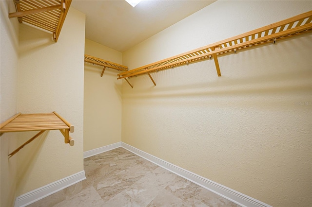 walk in closet featuring tile flooring