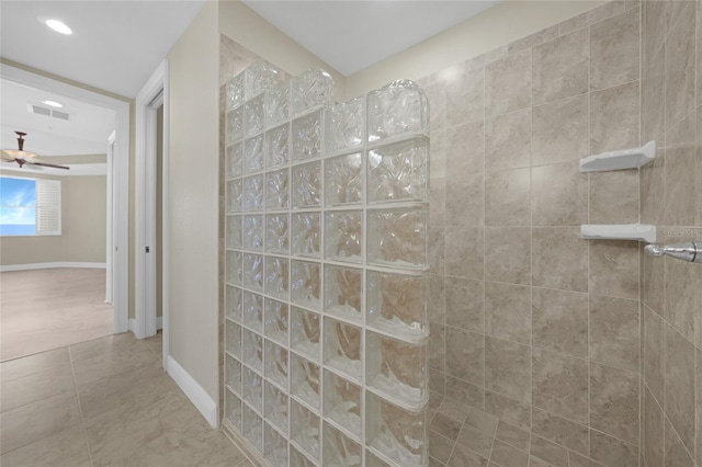 bathroom with tile floors, ceiling fan, and a tile shower