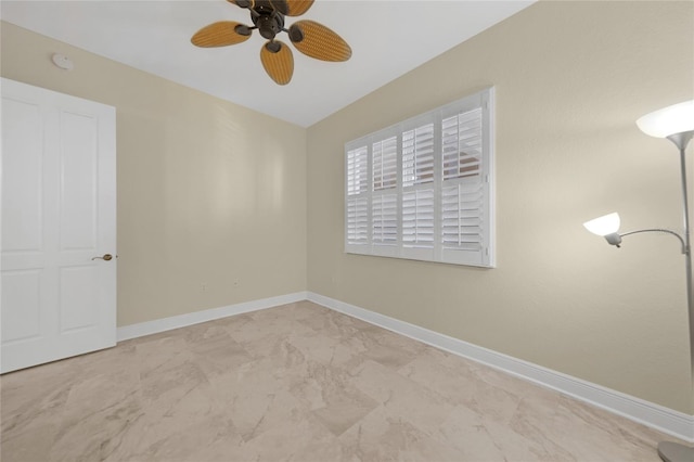 spare room featuring ceiling fan and tile floors