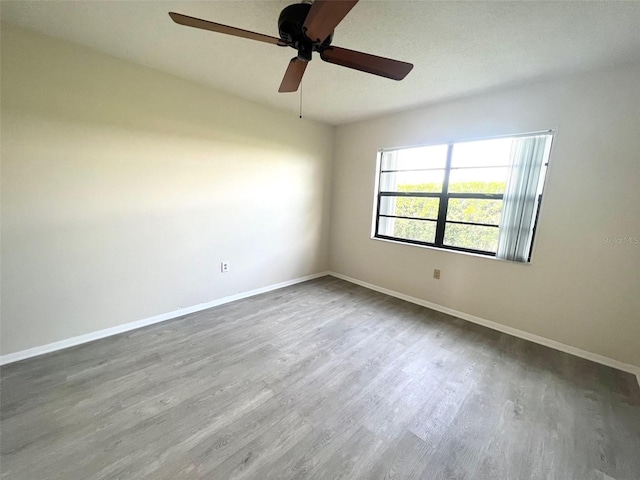 unfurnished room featuring ceiling fan and hardwood / wood-style flooring