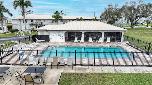 view of pool with a patio area and a lawn