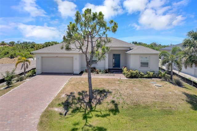 single story home featuring a garage and a front yard