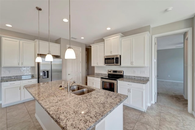 kitchen with white cabinetry, appliances with stainless steel finishes, sink, and an island with sink