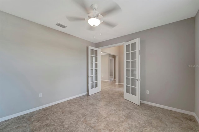 tiled spare room with ceiling fan and french doors