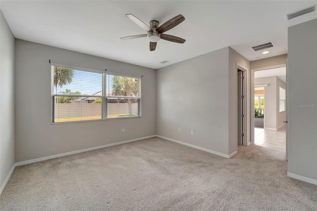 carpeted empty room featuring ceiling fan