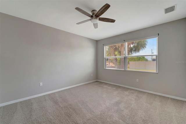 carpeted empty room featuring ceiling fan