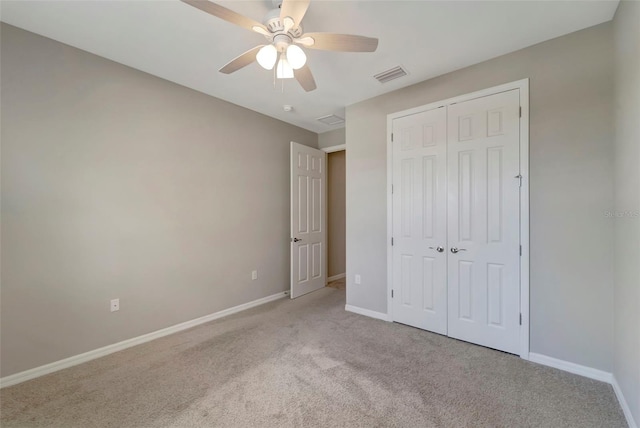 unfurnished bedroom featuring a closet, carpet, and ceiling fan