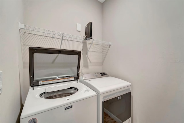 washroom with separate washer and dryer