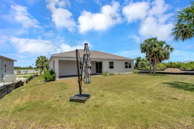 back of property featuring a lawn