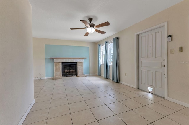 unfurnished living room featuring ceiling fan, light tile patterned floors, and a fireplace